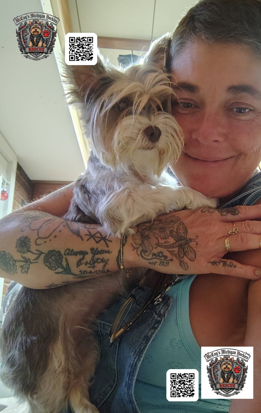 A woman smiling while cuddling a small gray and white Yorkshire Terrier close to her cheek